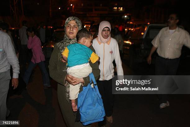 Civilians evacuate from the Palestinian refugee camp Nahr al-Bared to flee the ongoing gun fire May 22, 2007 in Tripoli, Lebanon. Islamic militants...