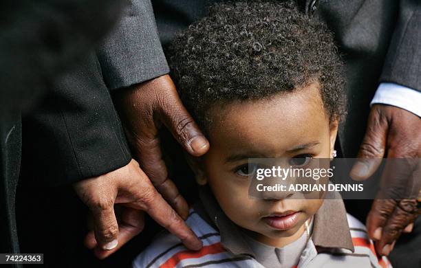 London, UNITED KINGDOM: Julien Bancoult, grandson of Louis Olivier Bancoult, Chairman of the Chagos Refugees Group stands beside his relatives...