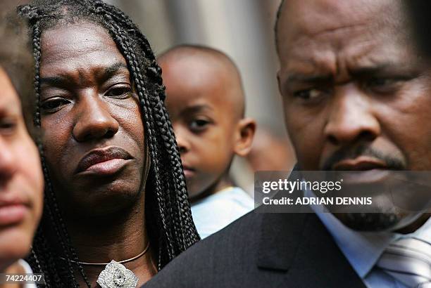 London, UNITED KINGDOM: Chagos Islanders look on while Louis Olivier Bancoult , Chairman of the Chagos Refugees Group, addresses the media outside...