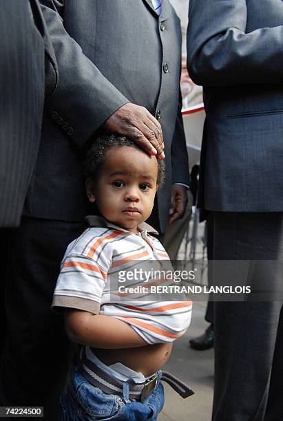 London, UNITED KINGDOM: Julien Bancoult, grandson of Louis Olivier Bancoult, Chairman of the Chagos Refugees Group stands beside his relatives...