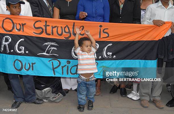 London, UNITED KINGDOM: Julien Bancoult, the grandson of Louis Olivier Bancoult, Chairman of the Chagos Refugees Group, celebrates outside The High...