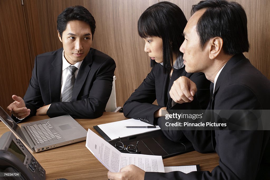 Business people in meeting around table in conference room