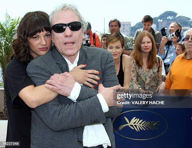 Italian actress Asia Argento hugs 23 May 2007 US director Abel Ferrara during a photocall for their film 'Go Go Tales' in the Festival Palace in...