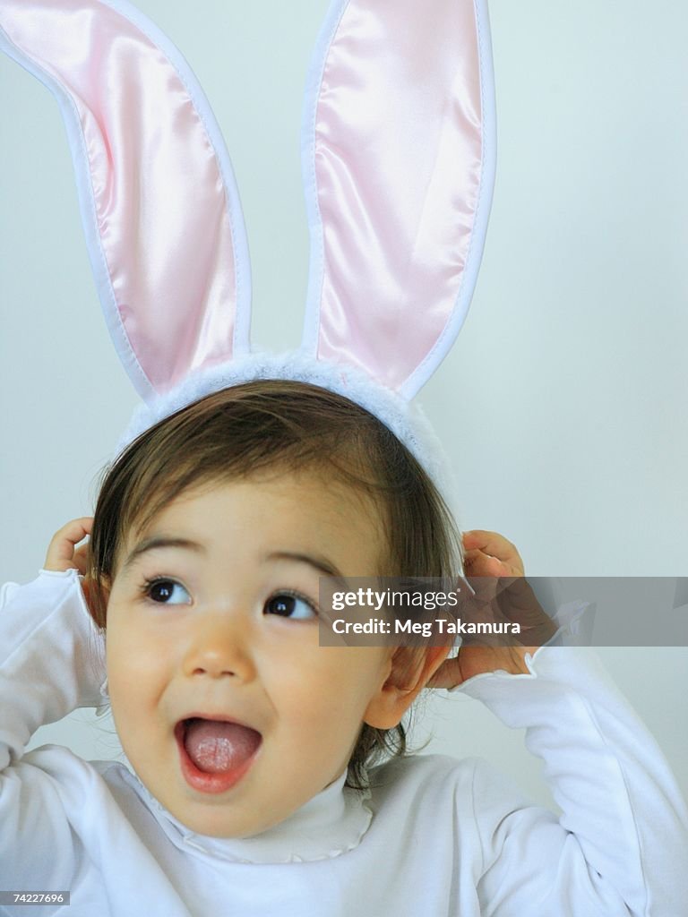 Close-up of a baby girl wearing a rabbit costume