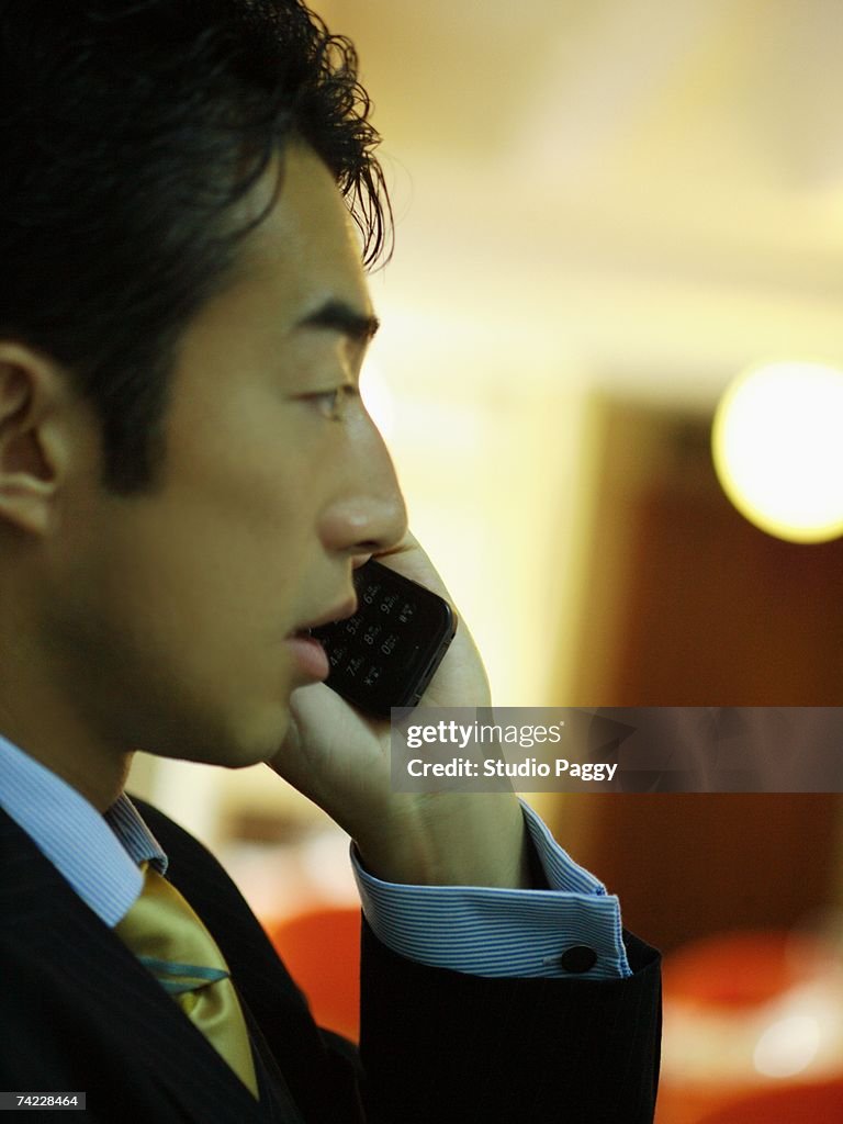 Side profile of a businessman using a mobile phone