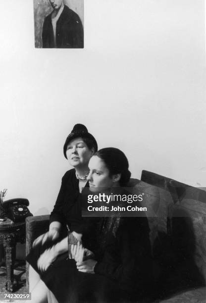 American artist Alice Neel and American dancer and choreographer Sally Gross sit together on a couch on the set of the Beat film 'Pull My Daisy,'...