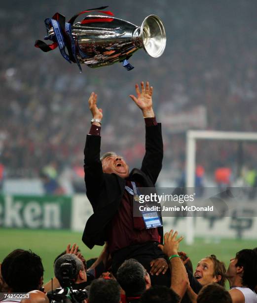 Carlo Ancelotti, the manager of AC Milan tosses the trophy into the air in celebration following his teams 2-1 victory during the UEFA Champions...