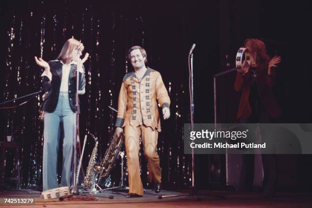 Neil Sedaka, American pianist and singer-songwriter, walks on to the stage to greet the audience during a live concert performance at the New...