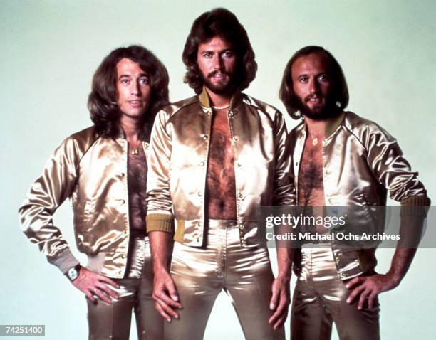 Disco group the Bee Gees pose for a portrait in gold lame outfits in 1977.