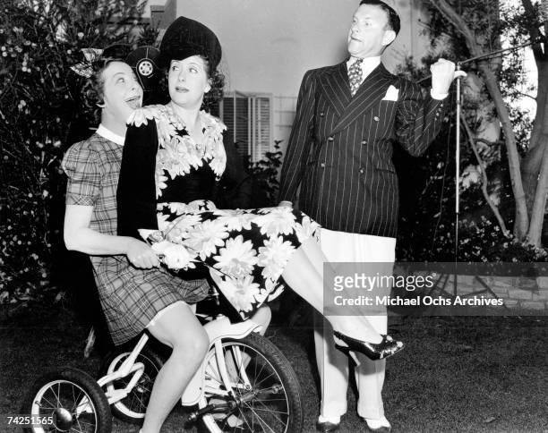 Entertainer Fanny Brice along with husband and wife comedy team George Burns and Gracie Allen ham it up for the camera at her birthday party on...