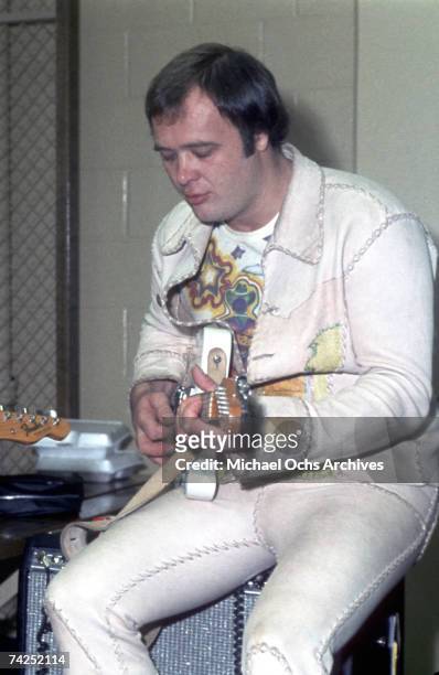 Singer David Clayton-Scott of the rock and roll band "Blood Sweat & Tears" rehearses backstage on an electric guitar in circa 1971.