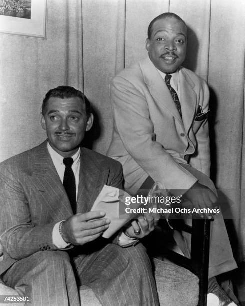 Big Band leader Count Basie and actor Clark Gable pose for a photo circa 1940.