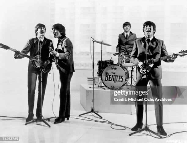 Rock and roll band "The Beatles" perform on a TV show in 1963.