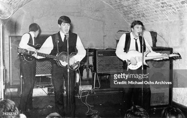 Rock and roll band "The Beatles" perform onstage at the Cavern Club on August 22, 1962. George Harrison, Paul McCartney, John Lennon.