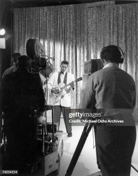 Rock and roll musician Chuck Berry plays his Gibson hollowbody electric guitar as he performs on "The Big Beat" hosted by Alan Freed and airing on...