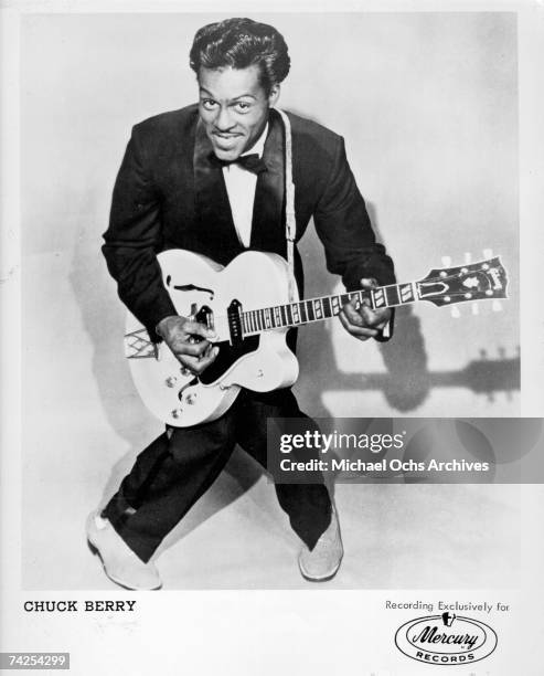 Rock and roll musician Chuck Berry poses for a portrait holding his Gibson hollowbody electric guitar in circa 1958.