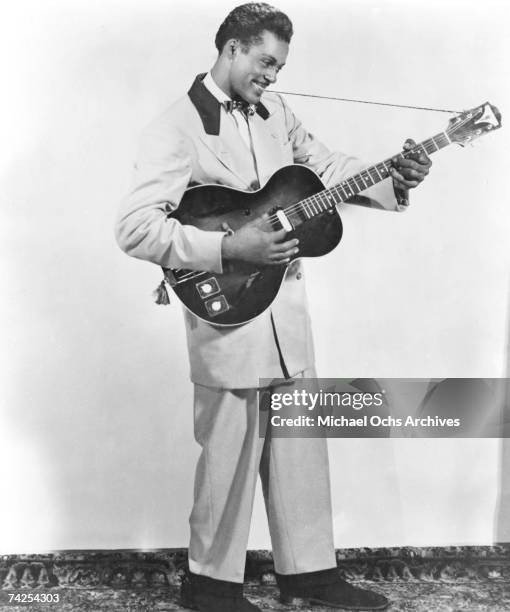 Rock and roll musician Chuck Berry poses for a portrait holding his Gibson hollowbody electric guitar in circa 1956.