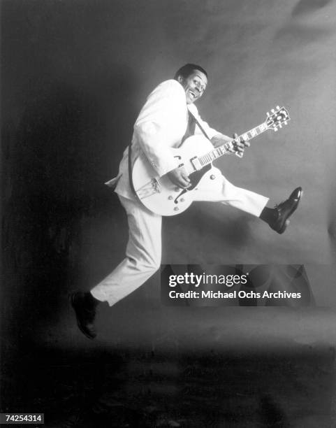 Rock and roll musician Chuck Berry poses for a portrait holding his Gibson hollowbody electric guitar in circa 1958.