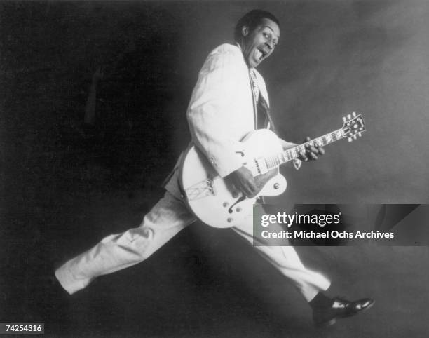 Rock and roll musician Chuck Berry poses for a portrait holding his Gibson hollowbody electric guitar in circa 1958.