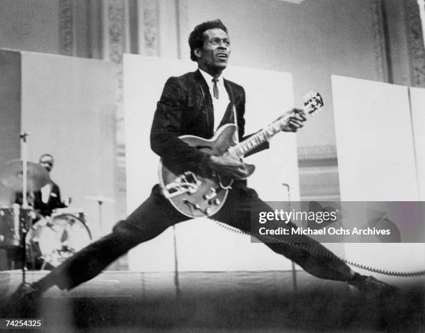 Rock and roll musician Chuck Berry does the splits as he plays his Gibson hollowbody electric guitar in circa 1968.