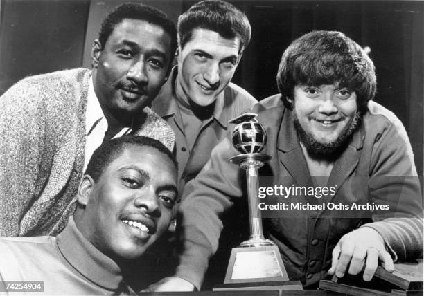 Booker T. Jones, Al Jackson, Steve Cropper and Donald 'Duck' Dunn of the R&B band Booker T. & The M.G.'s pose for a portrait with an award in circa...