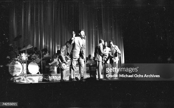 Soul singer James Brown performs onstage with Johnny Terry, Bobby Byrd and Bobby Bennett of the Famous Flames at the Apollo Theatre in New York, New...