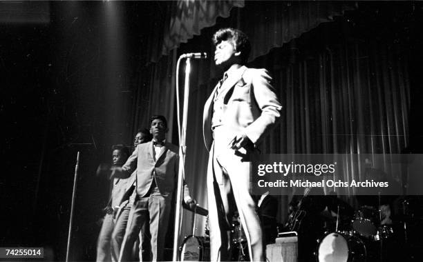 Soul singer James Brown performs onstage with Johnny Terry, Bobby Byrd and Bobby Bennett of the Famous Flames at the Apollo Theatre in New York, New...