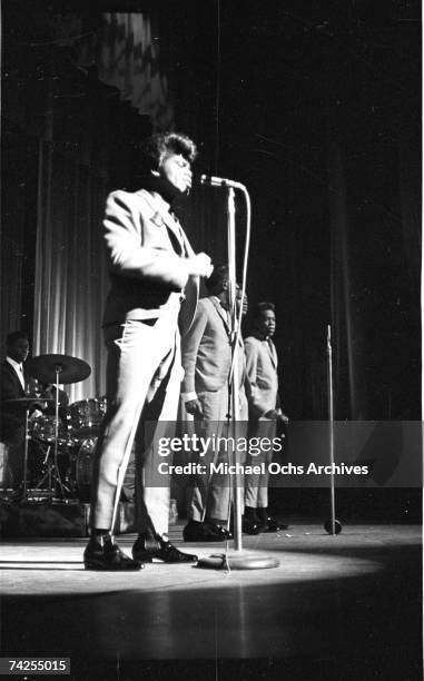 Soul singer James Brown performs onstage with Johnny Terry, Bobby Byrd and Bobby Bennett of the Famous Flames at the Apollo Theatre in New York, New...