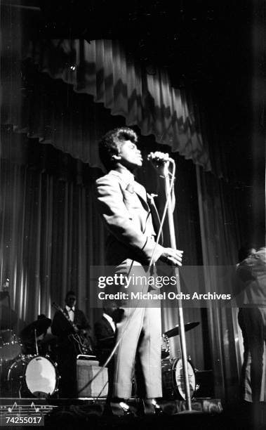 Soul singer James Brown performs onstage with Johnny Terry, Bobby Byrd and Bobby Bennett of the Famous Flames at the Apollo Theatre in New York, New...
