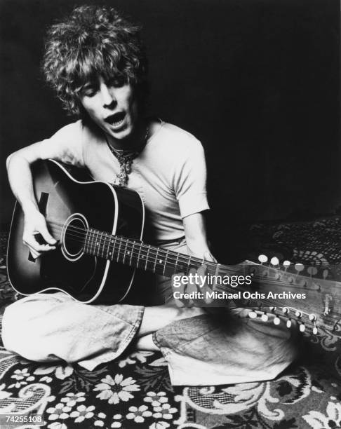Musician David Bowie plays an acoustic Espana 12-string guitar to promote the release of his album "Space Oddity" in November 1969 in London, England.