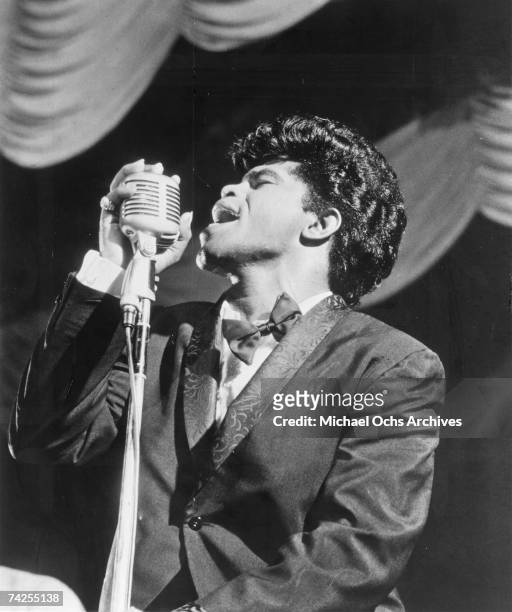 Soul singer James Brown sings in to a vintage microphone as he performs onstage in 1962 in New York, New York.