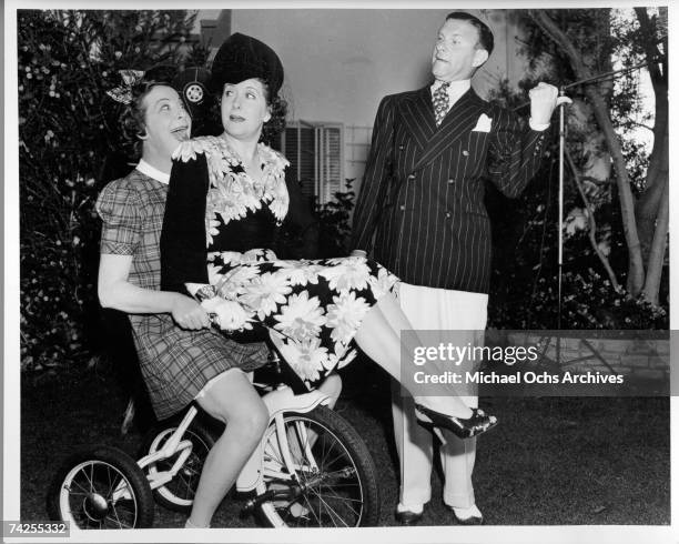 Entertainer Fanny Brice along with husband and wife comedy team George Burns and Gracie Allen ham it up for the camera at her birthday party on...