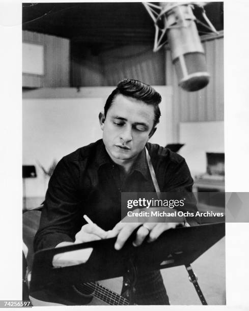 Country singer/songwriter Johnny Cash records in the studio in 1960.