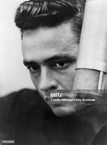 Country singer/songwriter Johnny Cash records in the studio in 1960.