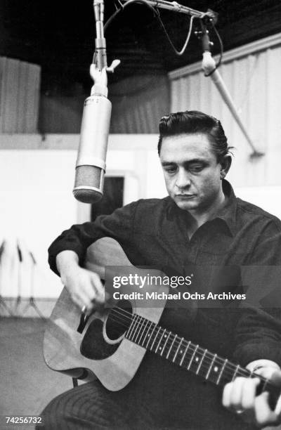 Country singer/songwriter Johnny Cash records in the studio in circa 1960.