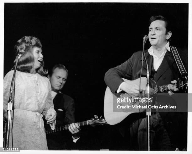 Married country singers Johnny Cash and June Carter Cash perform onstage in 1968 in Los Angeles, California.