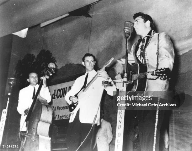 Country singer Johnny Cash performs on the WSM Grand Ole Opry tour with his band the Tennessee Two which included bassist Marshall Grant and...
