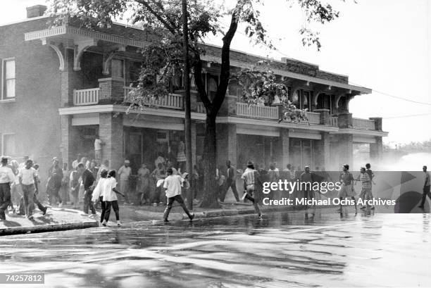 African American children are attacked by dogs and water cannons during a protest against segregation organized by Reverend Dr. Martin Luther King...