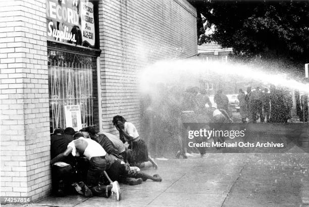 African American children are attacked by dogs and water cannons during a protest against segregation organized by Reverend Dr. Martin Luther King...