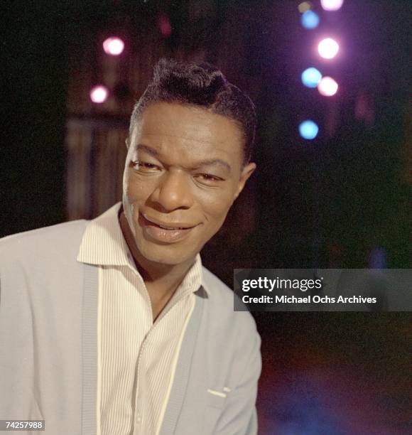 Singer Nat "King" Cole records during a session in the Capitol Recording Studios in circa 1964 in Los Angeles, California.