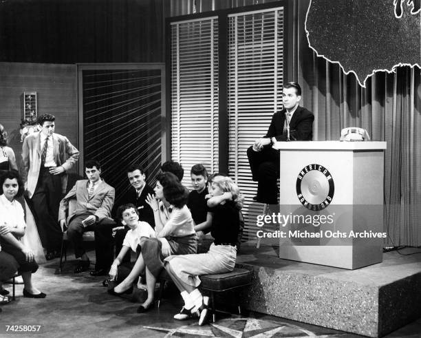 Television host Dick Clark presides over the set of his show "American Bandstand" as teenagers dance to top 40 popular music in circa 1958 in...