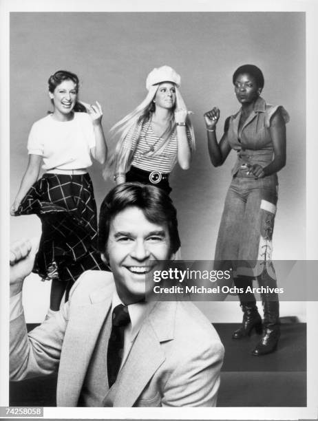 Television host of "American Bandstand" Dick Clark poses for a portrait with some dancers behind him in circa 1970.