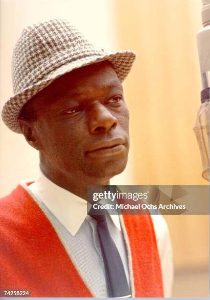 Singer Nat "King" Cole records during a session in the Capitol Recording Studios in circa 1964 in Los Angeles, California.