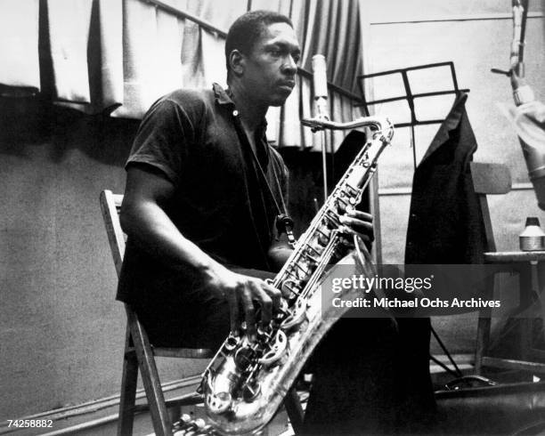 Jazz saxophonist John Coltrane records in the studio in circa 1958.