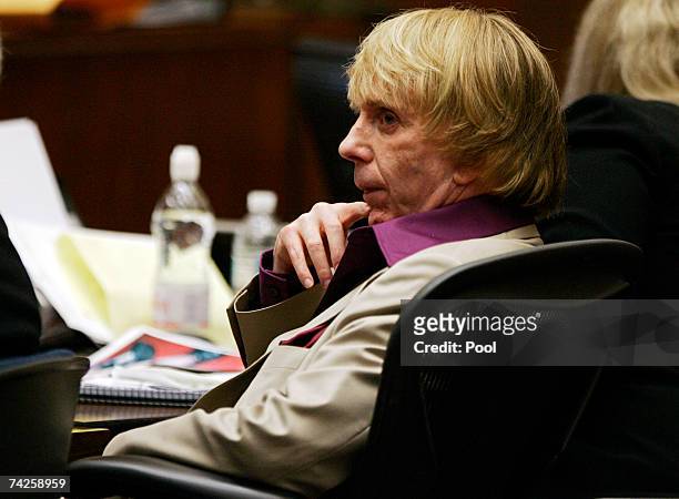 Music producer Phil Spector sits inside the courtroom as photos of actress Lana Clarkson's body are shown as evidence during his murder trial at Los...