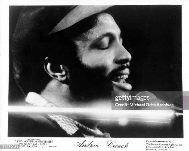 Singer and composer Andrae Crouch plays the piano as he sings in to a microphone in circa 1976.