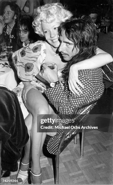 Alice Cooper with Pamela Des Barres and Rodney Bingenheimer in the background.