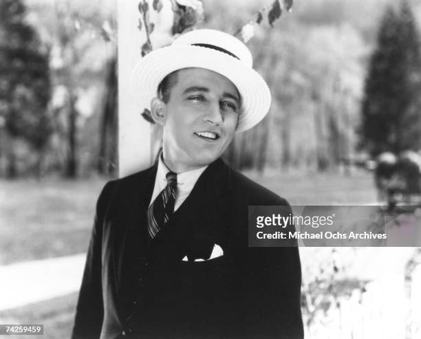 Entertainer Bing Crosby wears a white hat as he performs in a still from a movie in circa 1940.