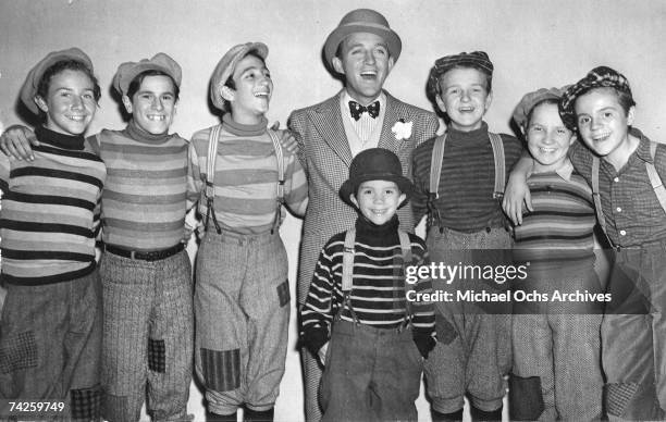 Entertainer Bing Crosby singing with a group of newsboys from the musical, 'The Star Maker', directed by Roy Del Ruth, 1939. The boys are Don...