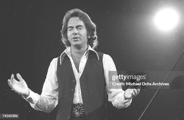 Singer Neil Diamond performs onstage wearing a sequin shirt in circa 1977 in Los Angeles, California.